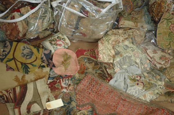 A GROUP OF TAPESTRY AND NEEDLEWORK, 17th Century, : A GROUP OF TAPESTRY AND NEEDLEWORK, 17th Century, including large aubusson fragments, seat covers, cushions, window valances and binding tape, along with 19th century weaving 5 spindles and yarns.