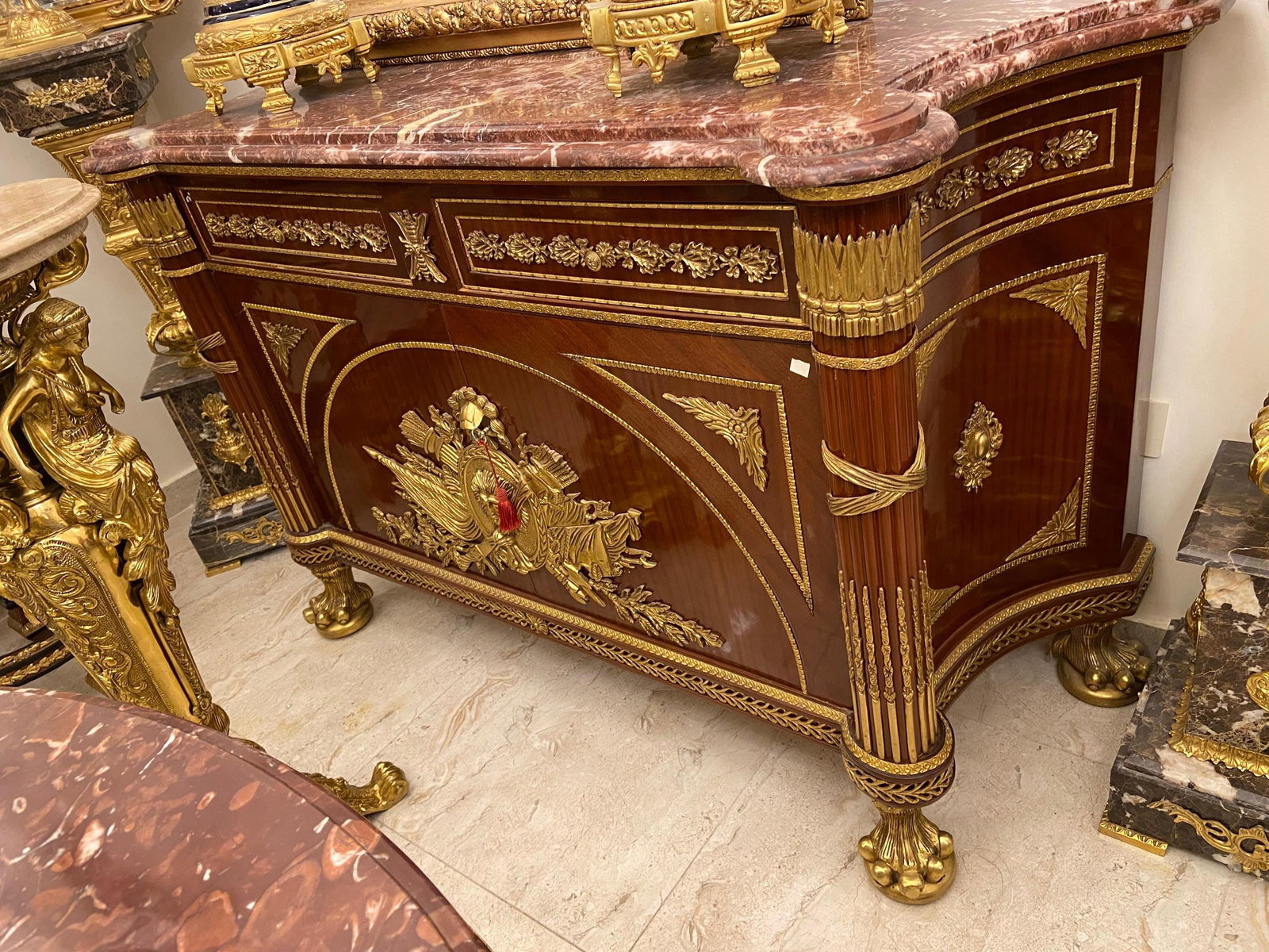 French Empire Style Ormolu-Mounted Commode with: Dimensions Width: 150 cm (59 in) Height: 100 cm (39 in) Depth: 55 cm (22 in) Description: This exceptional French Empire style commode exemplifies refined Neoclassical design with its balance of symme