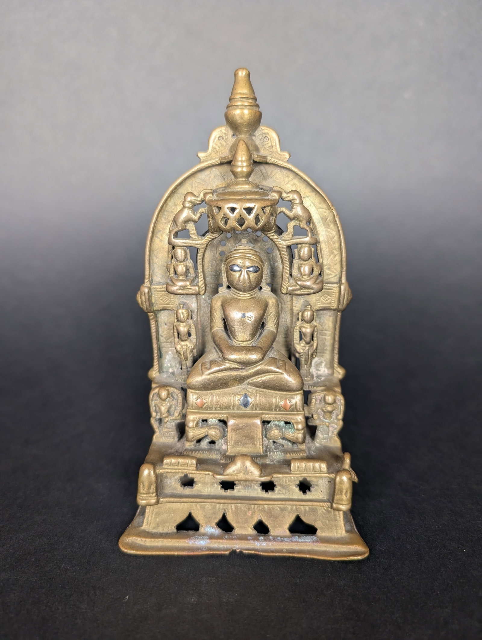 Jain Altar depicting Adinatha, 1st Tirthankara. 15th c. North Western India.: Adinatha, the 1st Tirthankara, appears as the central deity in this Jain Altar. There are lions at the base of his throne, and his Yakshi and Yaksha are positioned to the sides. Two devotees are stand