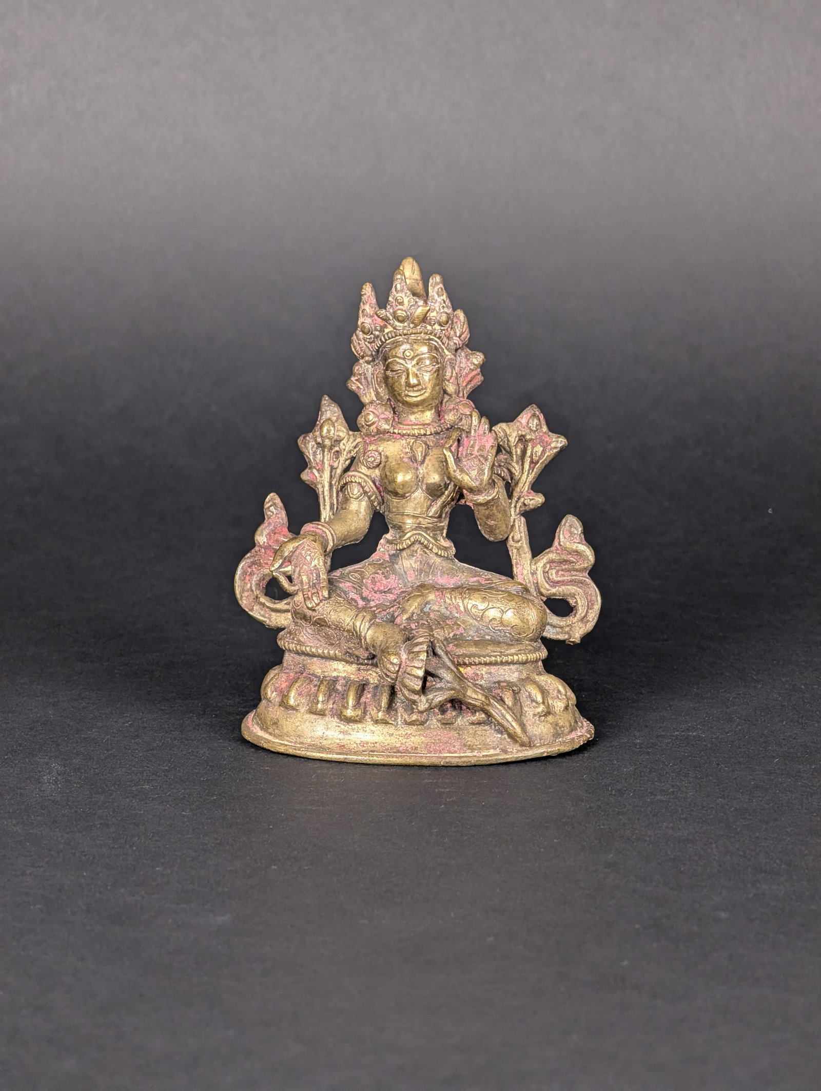 Green Tara, Nepal: Green Tara sits on her lotus throne with her right hand in Varada Mudra offering generosity and compassion, two of the traits symbolised by Green Tara. Her left hand is in Abhaya Mudra offering her