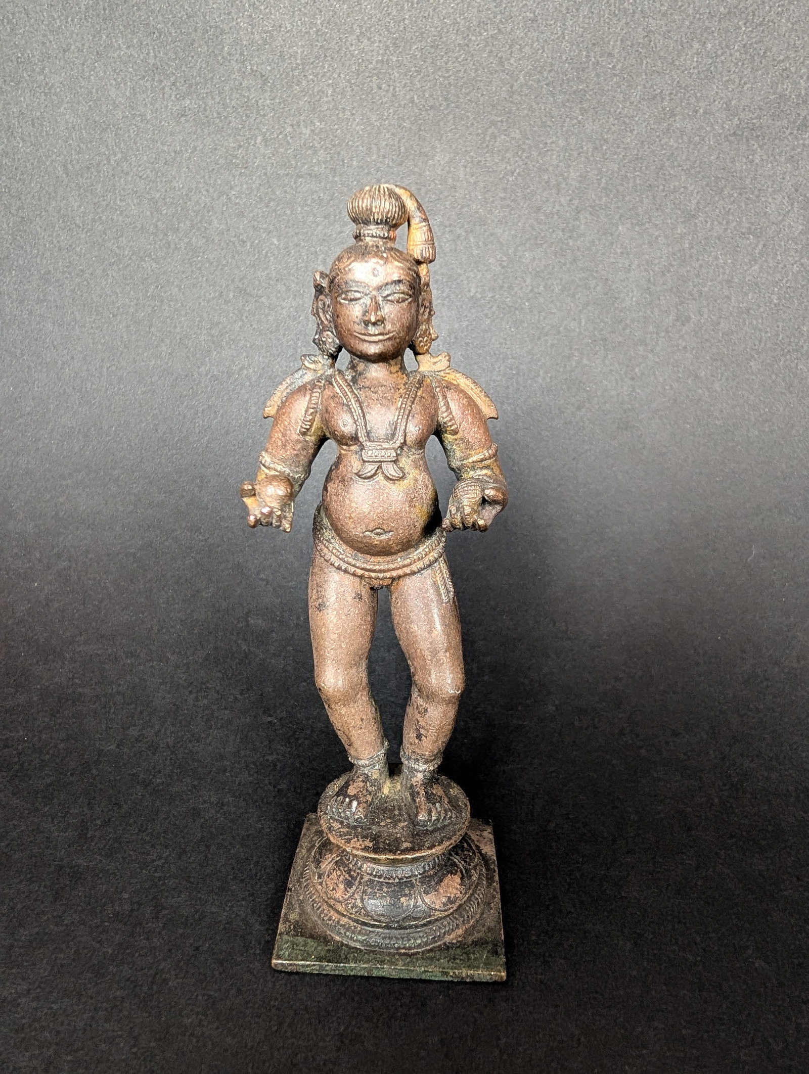 Krishna with two butterballs: This is Krishna holding butter balls in his hands. It is a special form and is frequently seen in much smaller bronzes. Krishna is an avatar of Vishnu. Going by his paunch, this may be from the Bellar