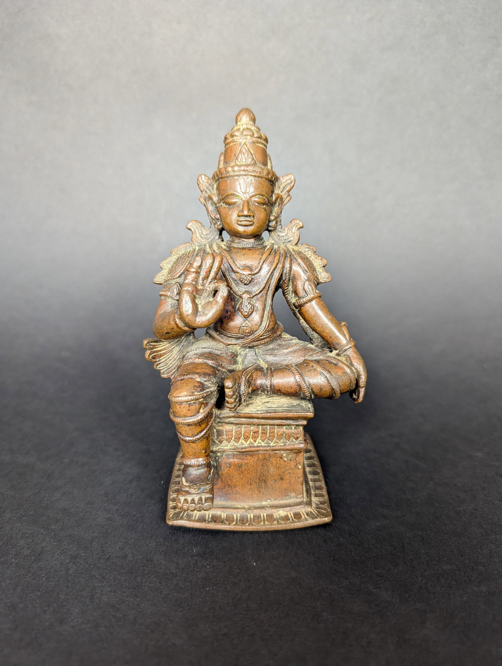 Seated Rama, Cin Mudra: Rama, an avatar of Vishnu, is sitting in lalitasana. His right hand is raised in Cin Mudra, espousing wisdom, and this mudra is often used when meditating. The ornamentation is extensive- jewellery,