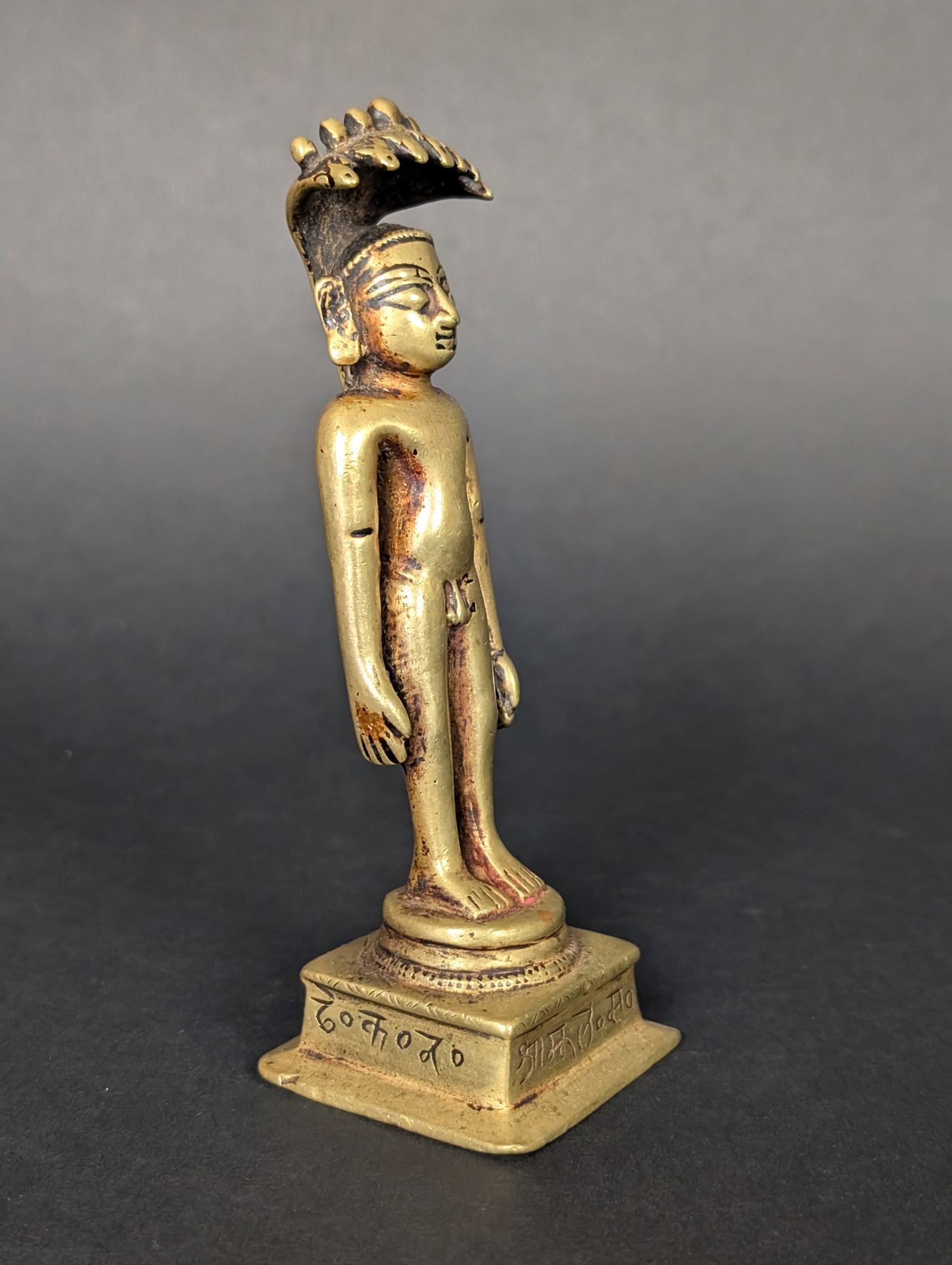 Standing Parsvanatha, Naked Jain Tirthankara: Lost-wax casting of Parsvanatha, the 23rd Tirthankara. The brightness of the metal alloy contains silver and gold to preserve the color without producing much oxidation. He stands on a round plinth on