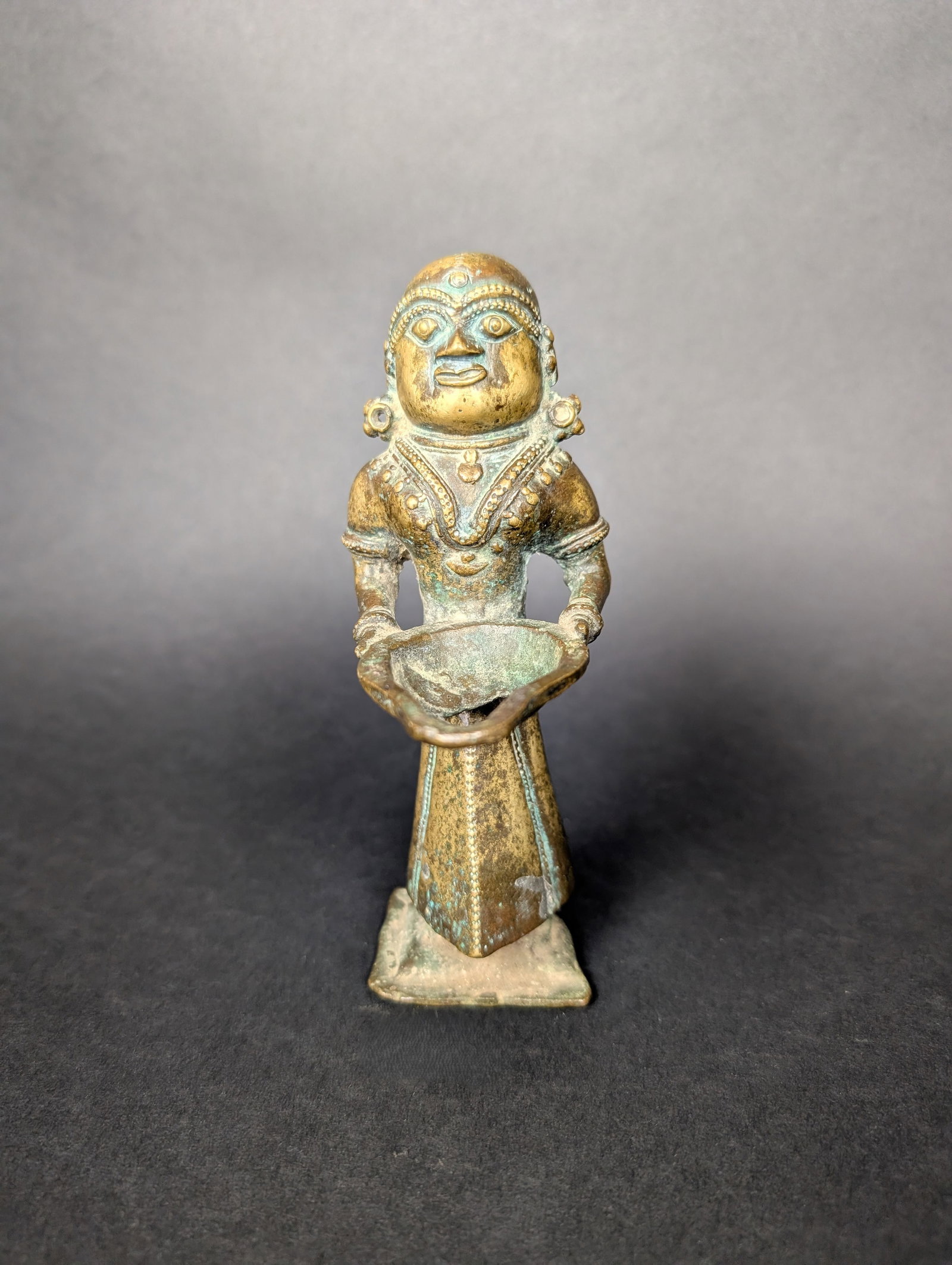 Tribal Deepalakshmi Lamp: This Deepalakshmi would have been used in a home shrine to illuminate the deity. The oil receptacle has developed a hole through use. Lovely features and decoration. Note her rows over her eyebrows wh
