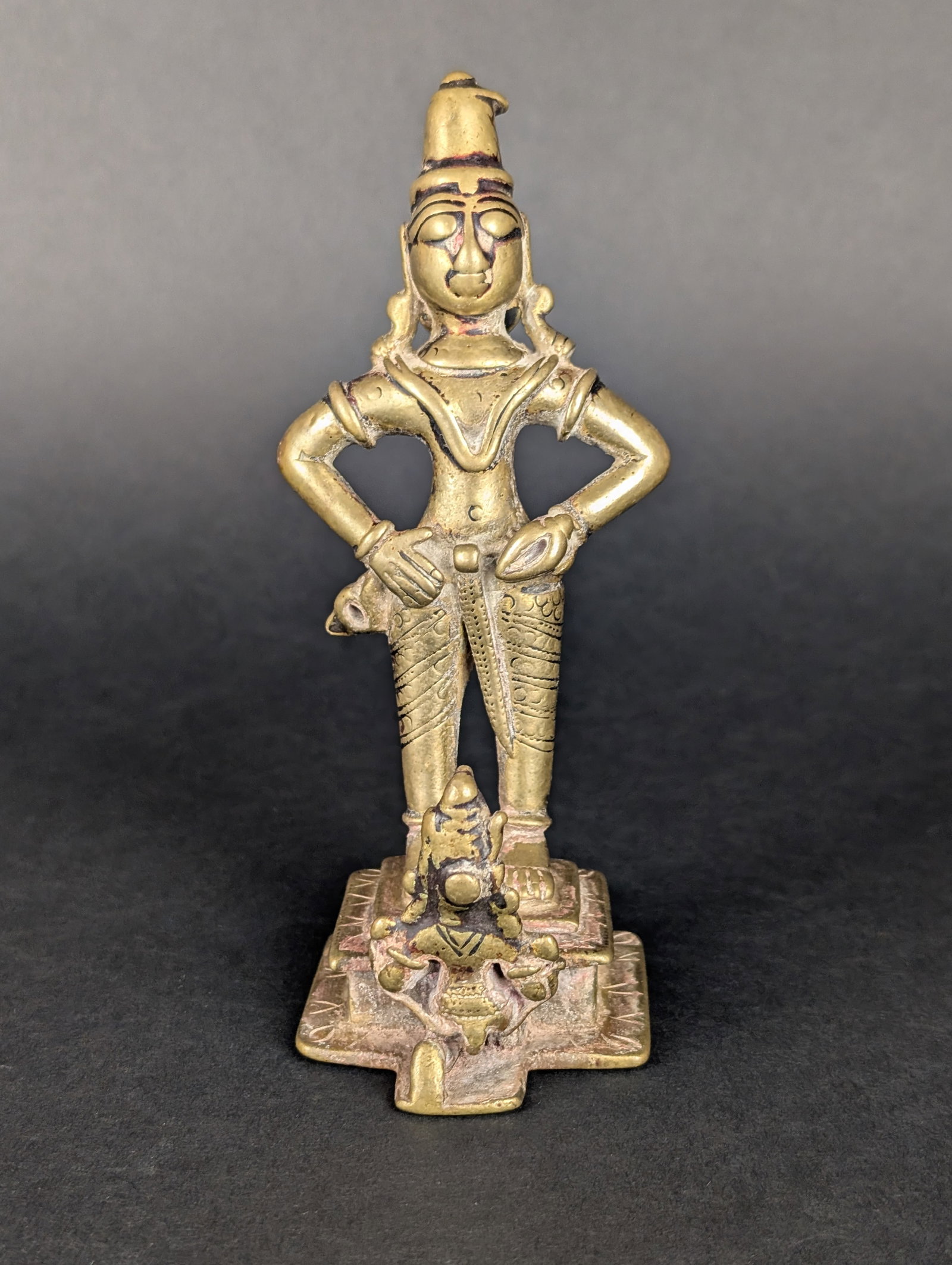 Vithoba with Garuda: Vithoba, a form of Vishnu, is the patron deity of Maharashtra. He generally stands with his arms akimbo, holding a conch and possibly another weapon-like object. His posture assures that he has contro