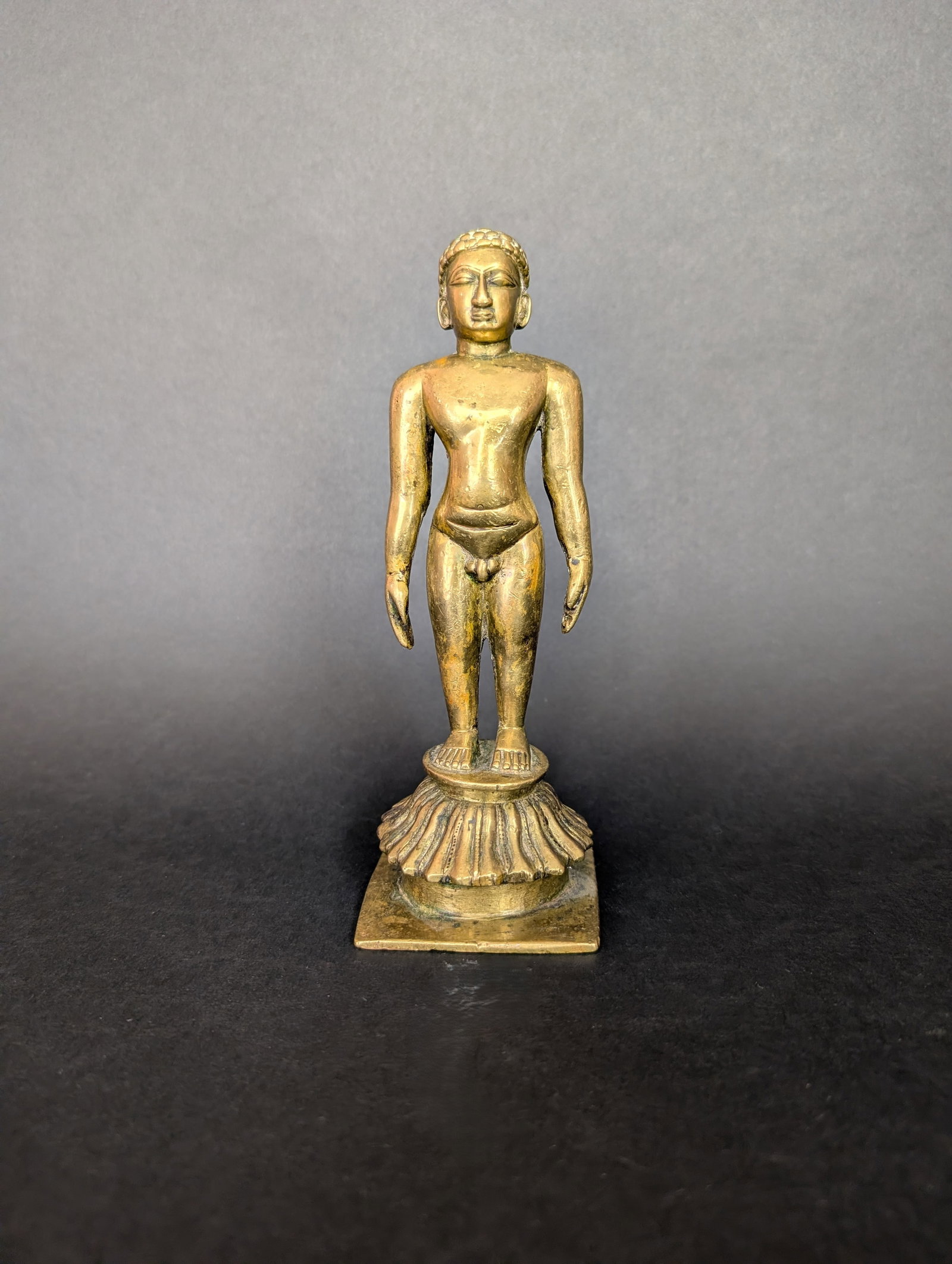 Standing Jain Tirthankara: The standing Jain Tirthankara does not have an insignia with which to identify him. He was likely part of a larger theme including a throne, which would have such information. The casting is likely to