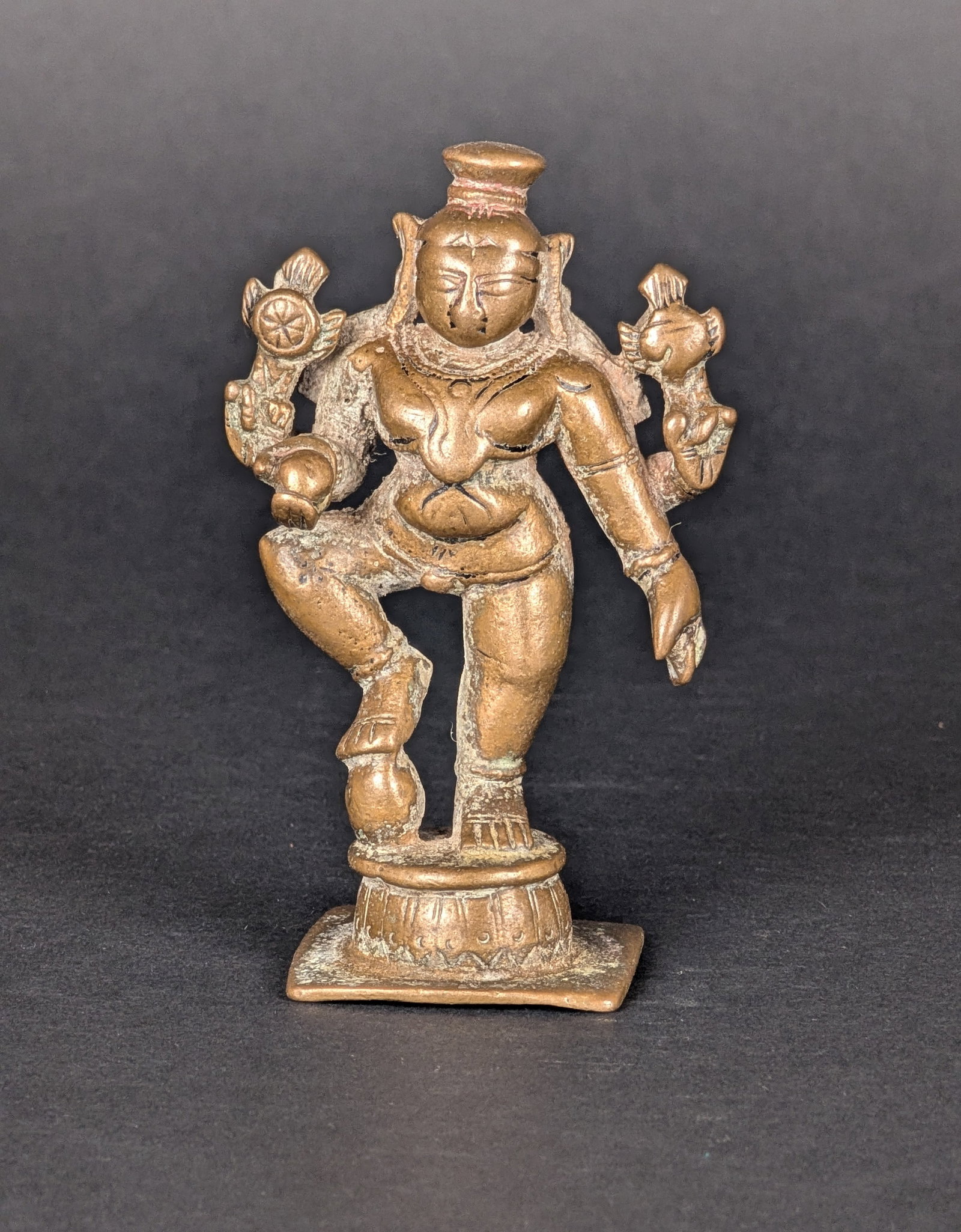 Four armed standing Krishna: Krishna is an avatar of Vishnu. In most depictions, he has only two arms. Here he is holding the Chakra and Shankha, attributes of Vishnu, in his rear hands. In his front arms, he holds a butterball