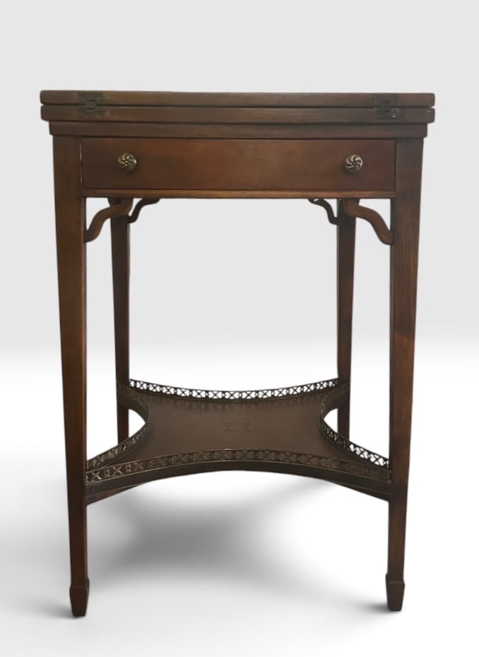 Theodore Alexander Mahogany and Leather Handkerchief Games Table: Theodore Alexander handkerchief games table with folding design, with one drawer and lower shelf. Handmade in Vietnam and retaining the maker's inspection label. The top expands from 21" to 42". Scatt