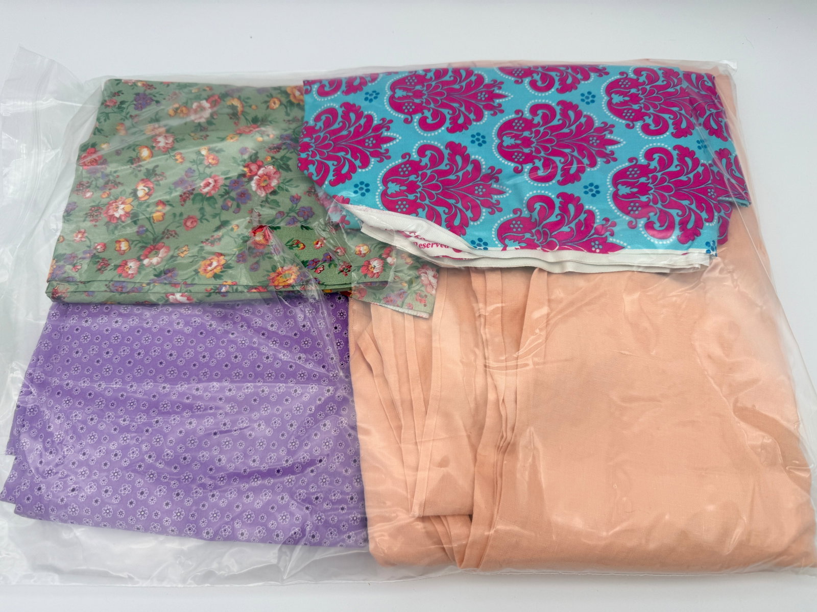 Fabric Remnant Lot: Mixed fabric pieces in assorted colors and prints. Age and fiber content unverified.