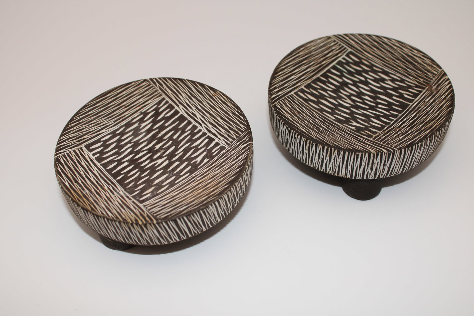 Pair of Hand carved B/W Tribal Style 3 Legged Decorative Stands: Each are 4" diameter x 1.5" tall