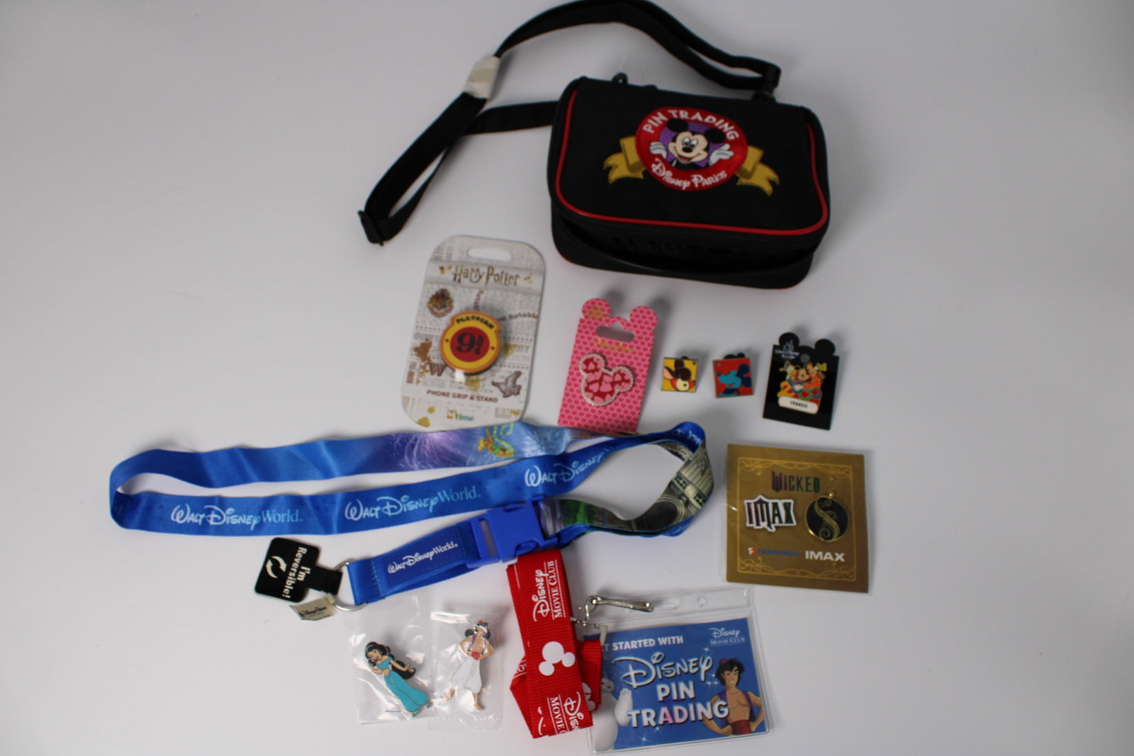 Disney Parks Trading Pin Collection Lot: 19 pins total, including 17 from Disney Parks; all retain retail backings. Includes pin trading bag, 2 lanyards and Harry Potter phone grip stand
