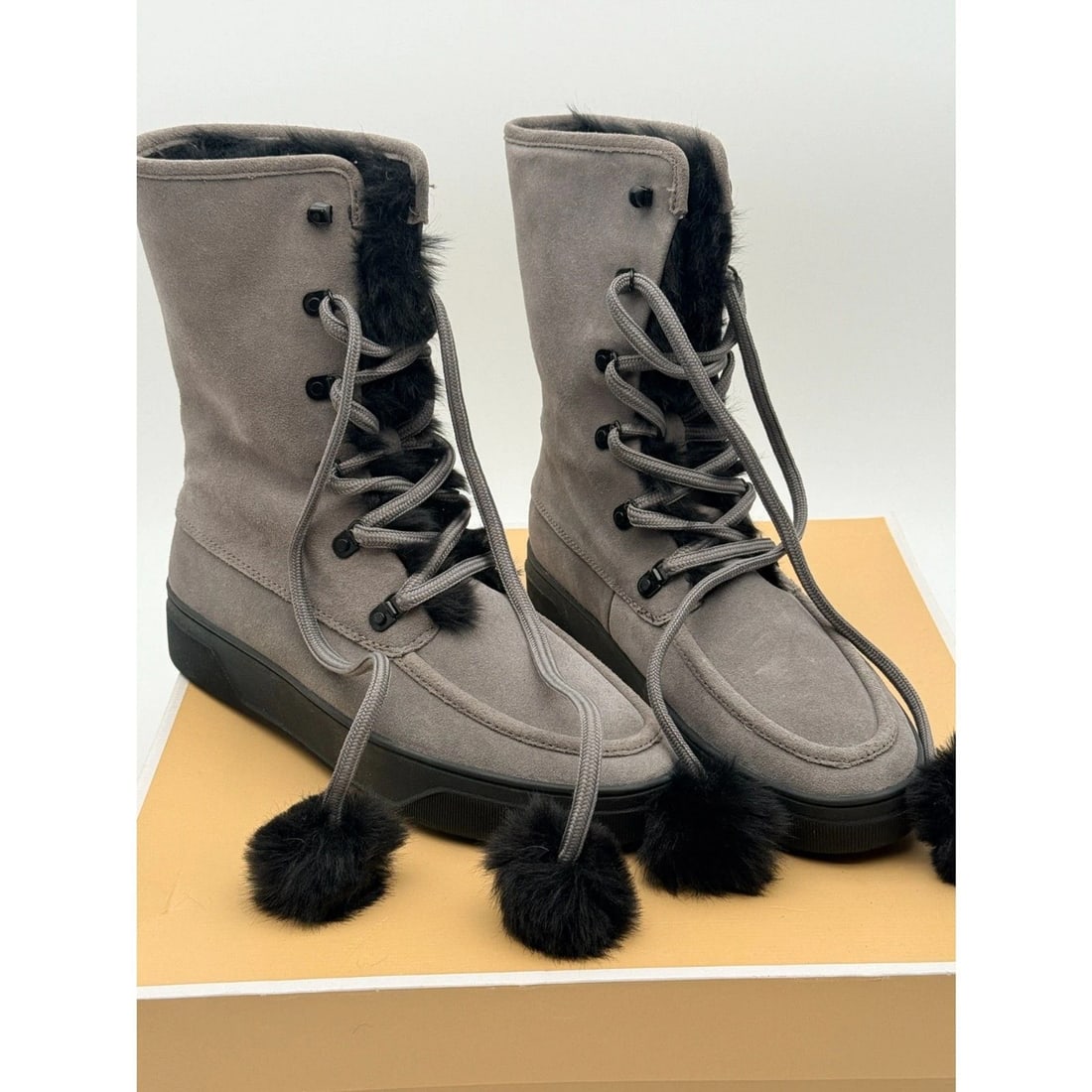 Michael Kors Juno Suede Lace-Up Boots Size 8M: Storm gray suede boots with black faux-fur trim and pom-pom laces. Includes original box. Minimally worn, if at all.