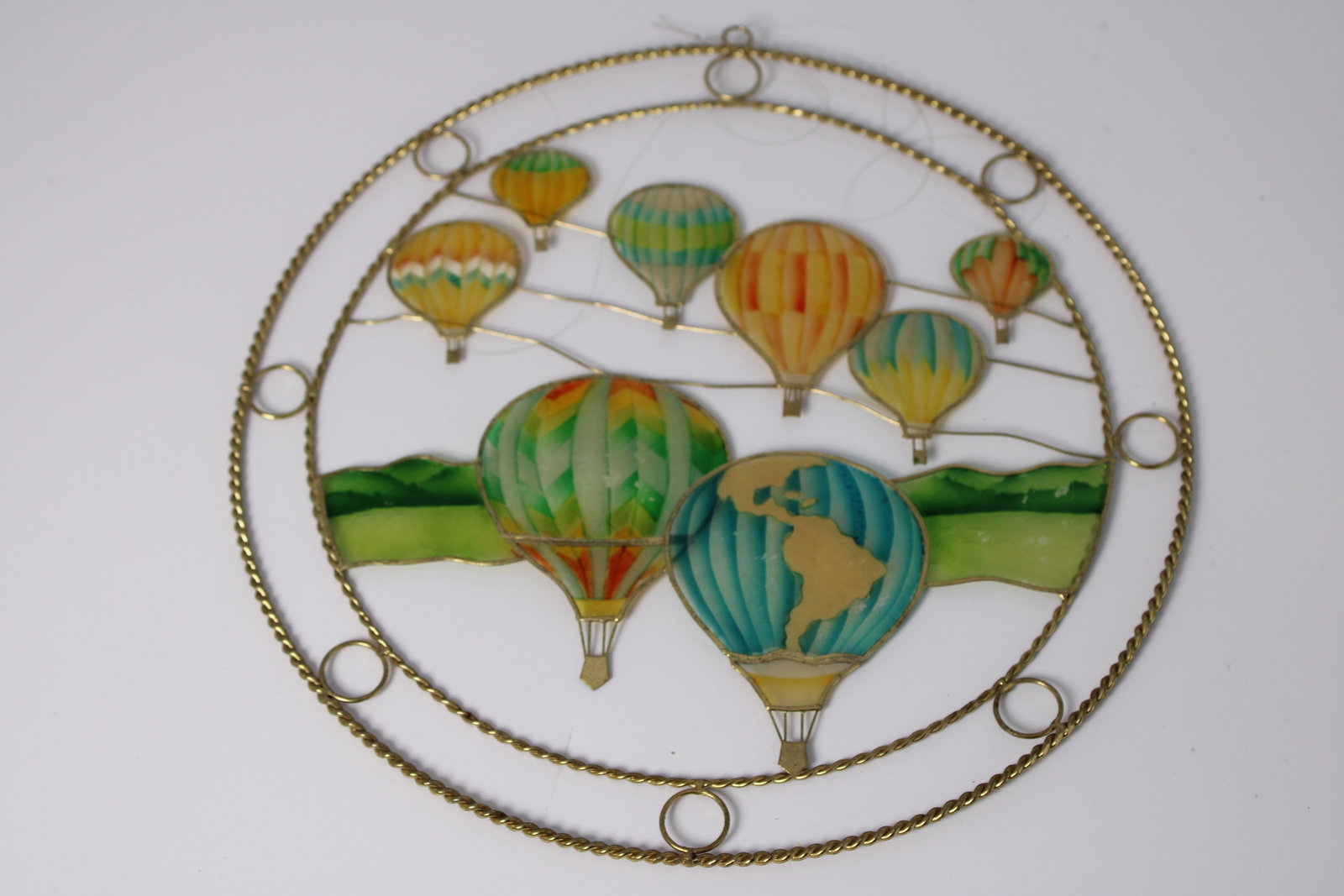 Capiz Shell Hot Air Balloon Wall Hanging: Circular brass-tone wall decor with colorful shell balloon scene; visible finish wear and discoloration