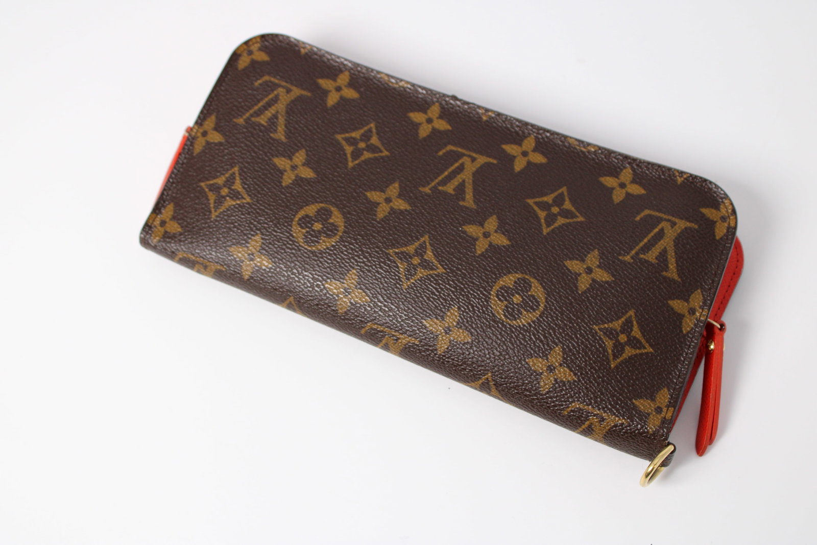 LV ? Brown Monogram-Style Zip Long Wallet: Brown LV monogram wallet with red interior, gold-tone hardware, double zipper, multiple card slots and zippered coin pocket; marked Louis Vuitton Paris Made in Spain, authenticity unknown