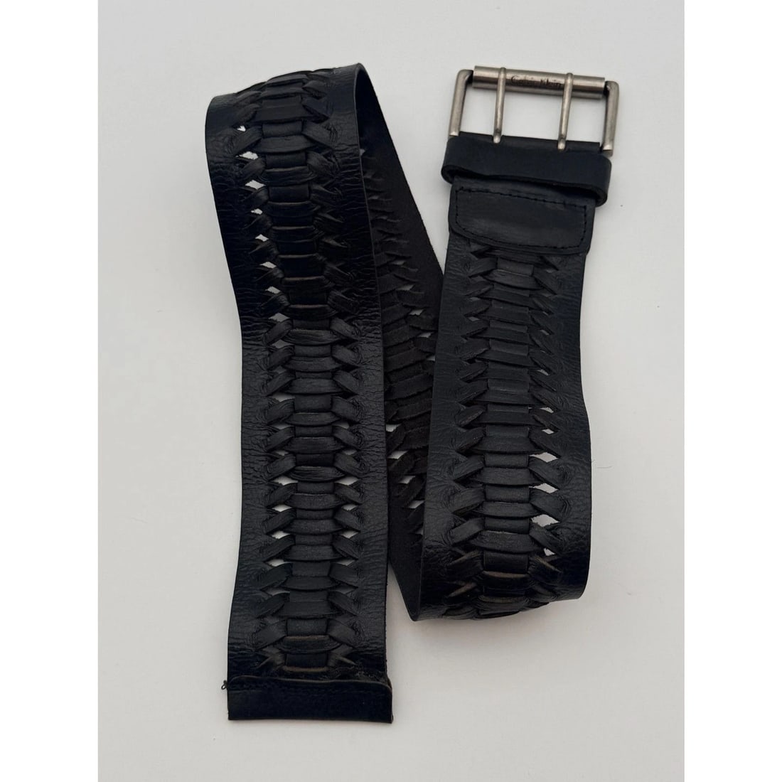 Calvin Klein Jeans Black Woven Leather Belt XS: Wide black woven leather belt with silver-tone double-prong buckle; style 434934CK0. Visible cracking and wear near buckle
