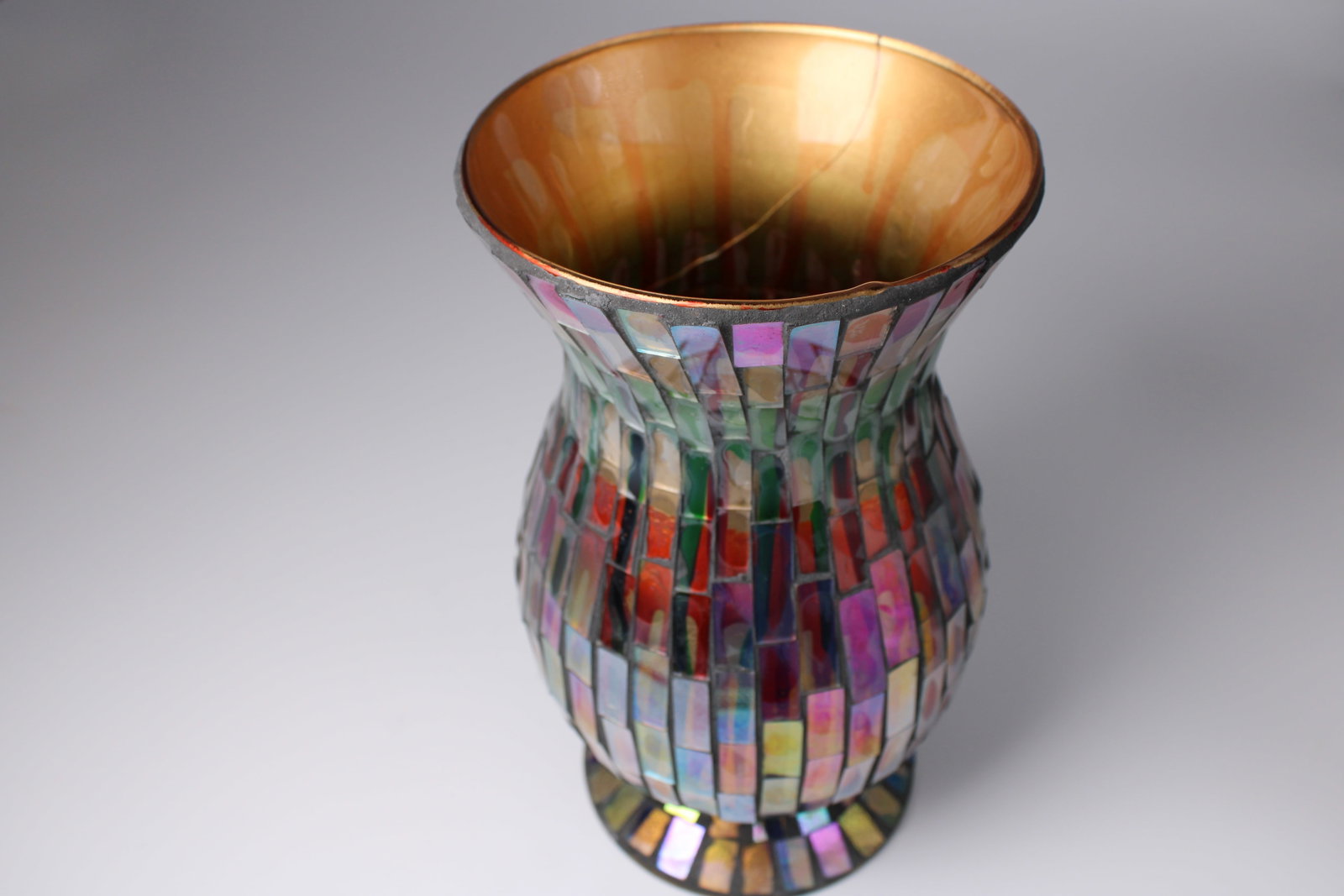 HomeGoods Multicolor Mosaic Glass Decor Vase: Contemporary HomeGoods decor vase with colorful iridescent mosaic glass tiles and a gold-tone interior. Interior crack does not extend through the exterior; vase remains structurally sound and display