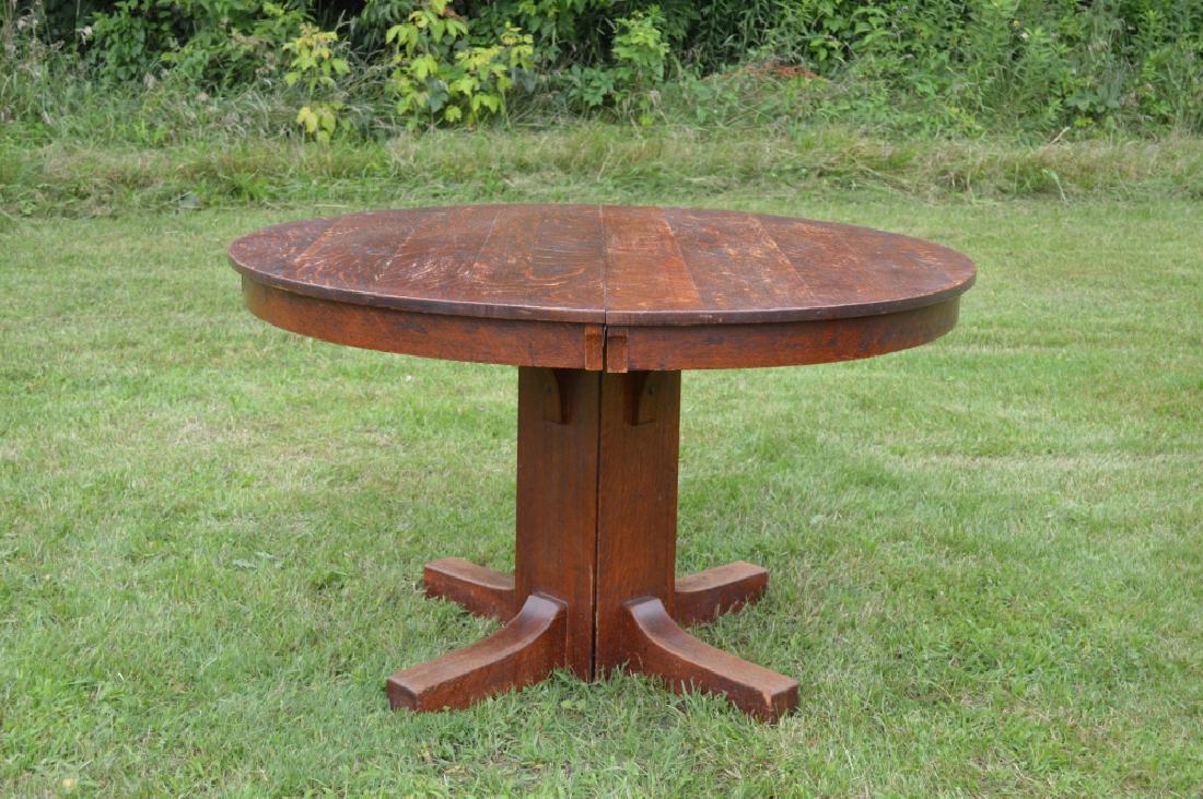 Limbert Pedestal Dining Room Table: with 2 leaves, quarter sawn oak, worn original finish, branded Limbert. 48" in diameter and 29" tall.