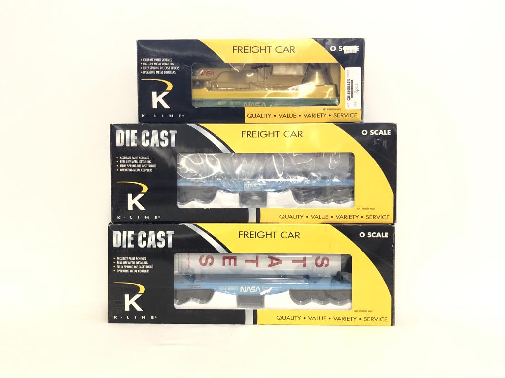 3 K-Line NASA Train Cars: K691-8015 Flat Car with Capsule and Helicopter K693-8012 Die Cast Flat Car with Rocket Stage Load K693-8011 Flat Car with USA Aluminum Rocket BoosterAll trains are from the Dwayne Martin Estate from G