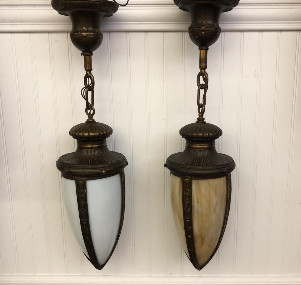Pair of Hanging Pendant Light Fixtures: one with caramel slag glass and one with white slag glass. Each comes with 4 panels of slag glass. Total length including chain is 27 inches. Approx. 7 inch in diameter at widest point. Both include c