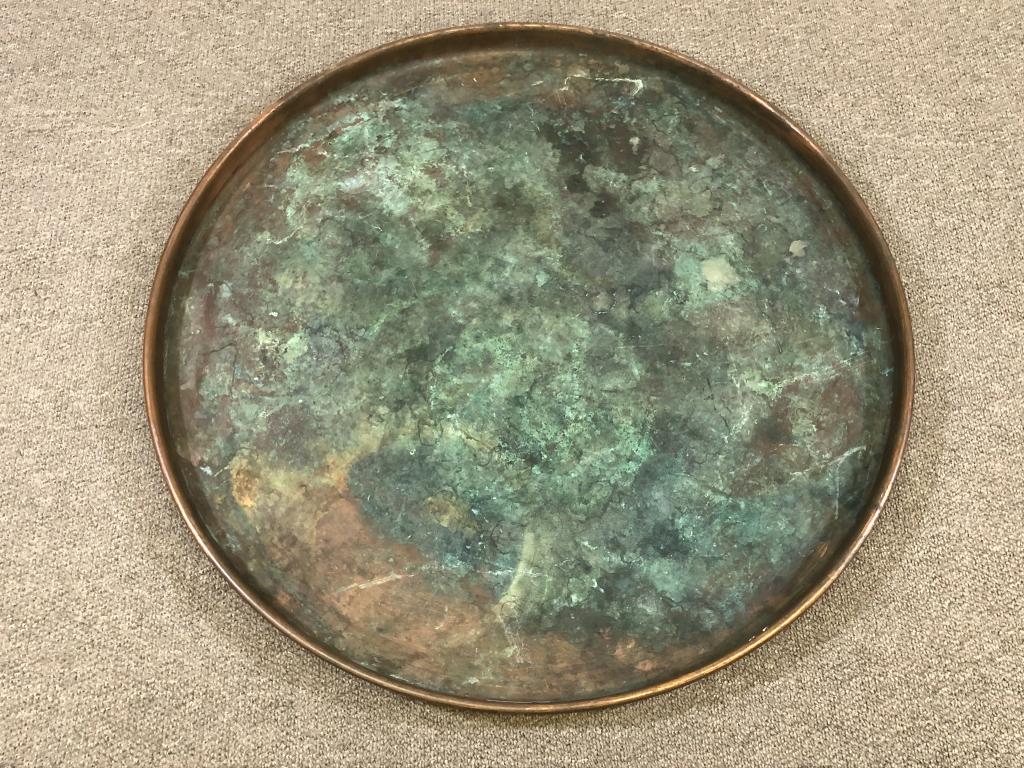 Large Copper Pan: 3 ft in diameter and 2 inches deep. Used to put winter boots on at Great Camp Kwenogamac, Long Lake, NY.