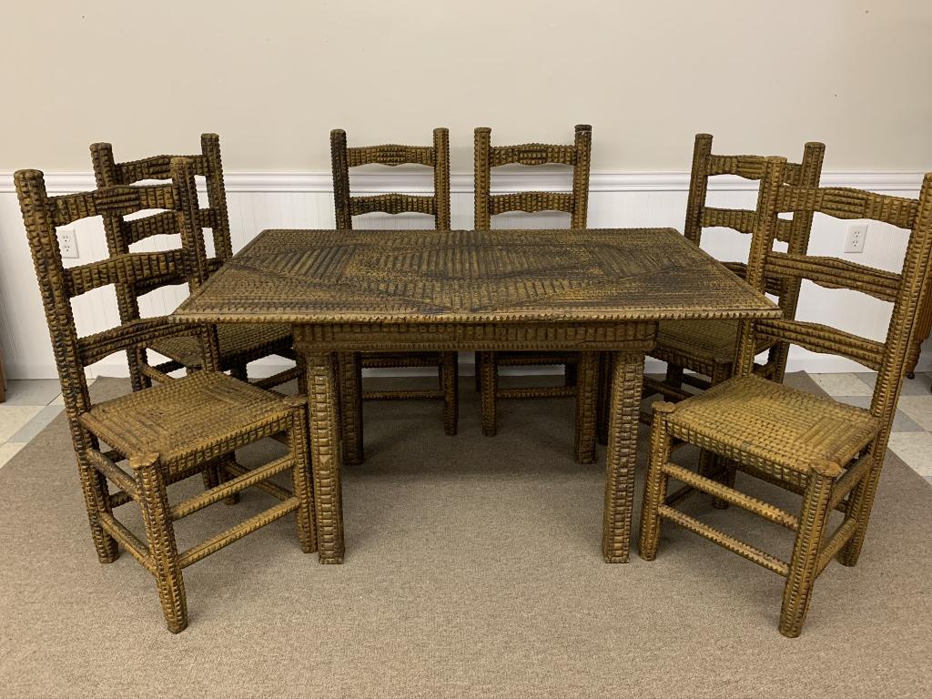 Tramp Art Dining Room Set: hand carved and painted. 6 ladderback side chairs and table. Chairs are 39 inches tall, 17 inches wide and 18 inches to top of seat. Table measures 33 1/2 inches x 53 1/2 inches x 30 1/2 inches tall.