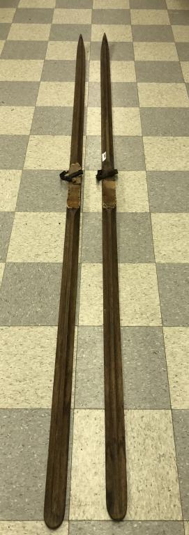 Pair of Vintage Touring Skis: 10' long with leather straps and pointed tips.