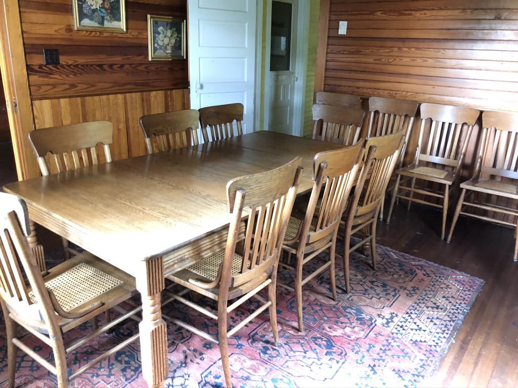 Golden Oak Dining Room Table and 12 Chairs: all refinished. 12 chairs with pressed caned seats and a 5 leg extension table with a 42 inch top and 5 additional 11" wide leaves. From a camp on Mount Arab Lake in the Adirondack Mountains.