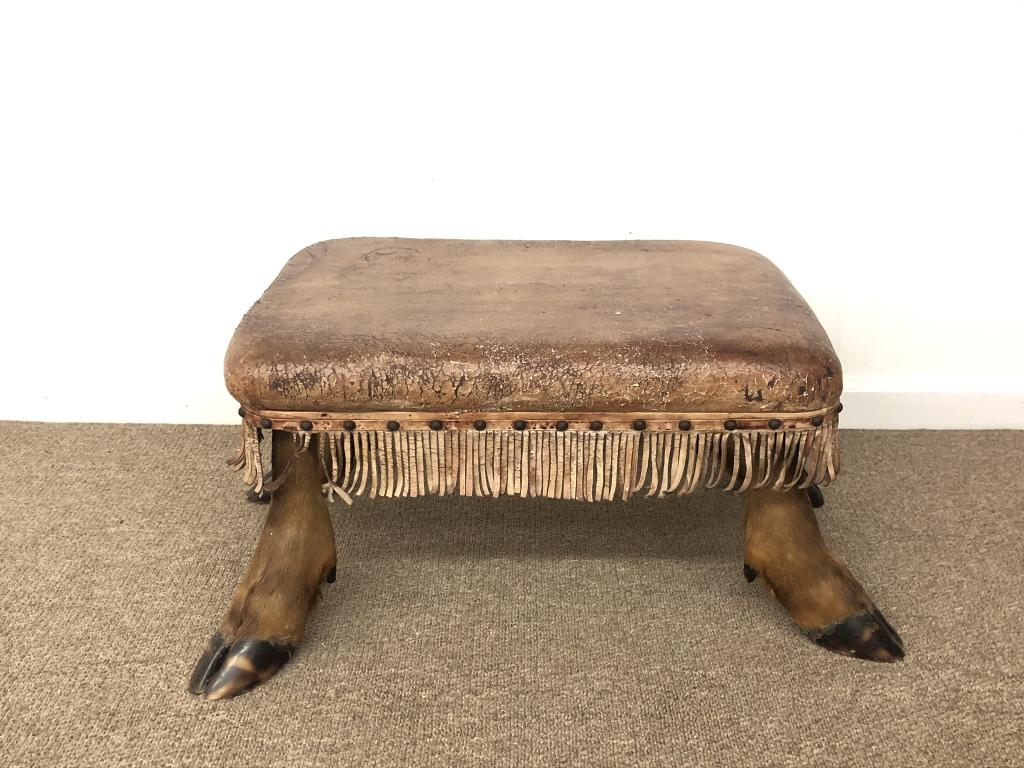 Elk Hoof Ottoman with a Leather Seat & Fringe: 16 inches x 24 inches x 14 inches tall. From a summer home on Upper Saranac Lake, Adirondack Mountains.