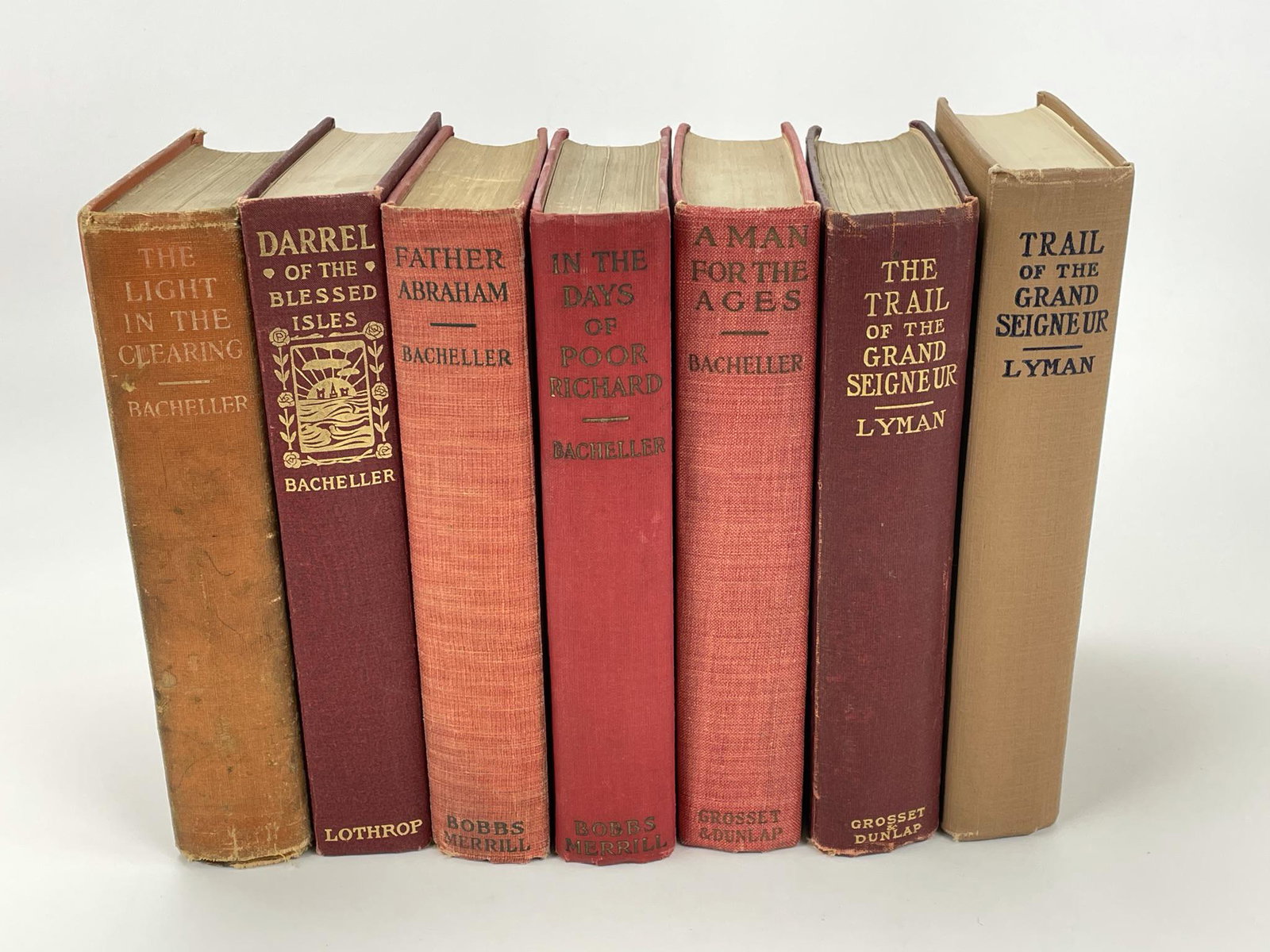 7 Hardcover Novels: 5 by Irving Bacheller and 2 by Olin Lyman. From the collection of Everett G. Foster (1942-2010) Clayton, NY. Mr. Foster was a former chair of The Clarkson University Board of Trustees, a Fiancier, Spo