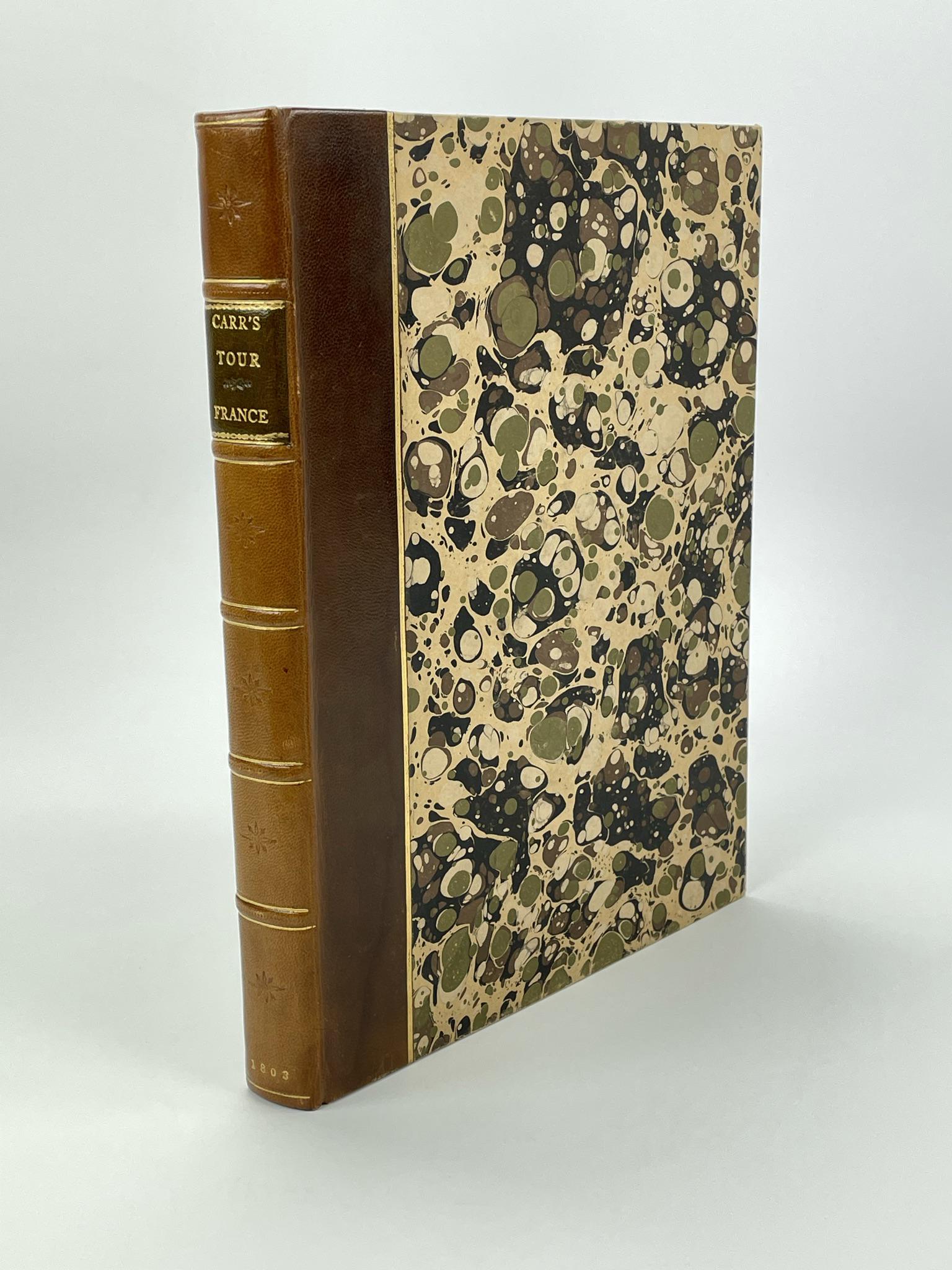 The Stranger in France by John Carr 1803: A Tour from Devonshire to Paris. Illustrated by Engravings in Aqua Tinta. Leather bound with marbleized boards. First edition with 12 hand colored aqua tints.