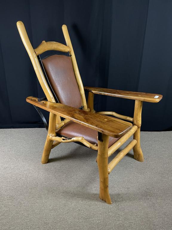 Freeform Contemporary Morris Chair by Goodspeed: signed and dated 2001. Chair is made of peeled maple limbs, walnut paddle arms, brown leather seat and back and an iron adjustable back rest. The chair is 4' tall x 40" deep x 34" wide. In very good c