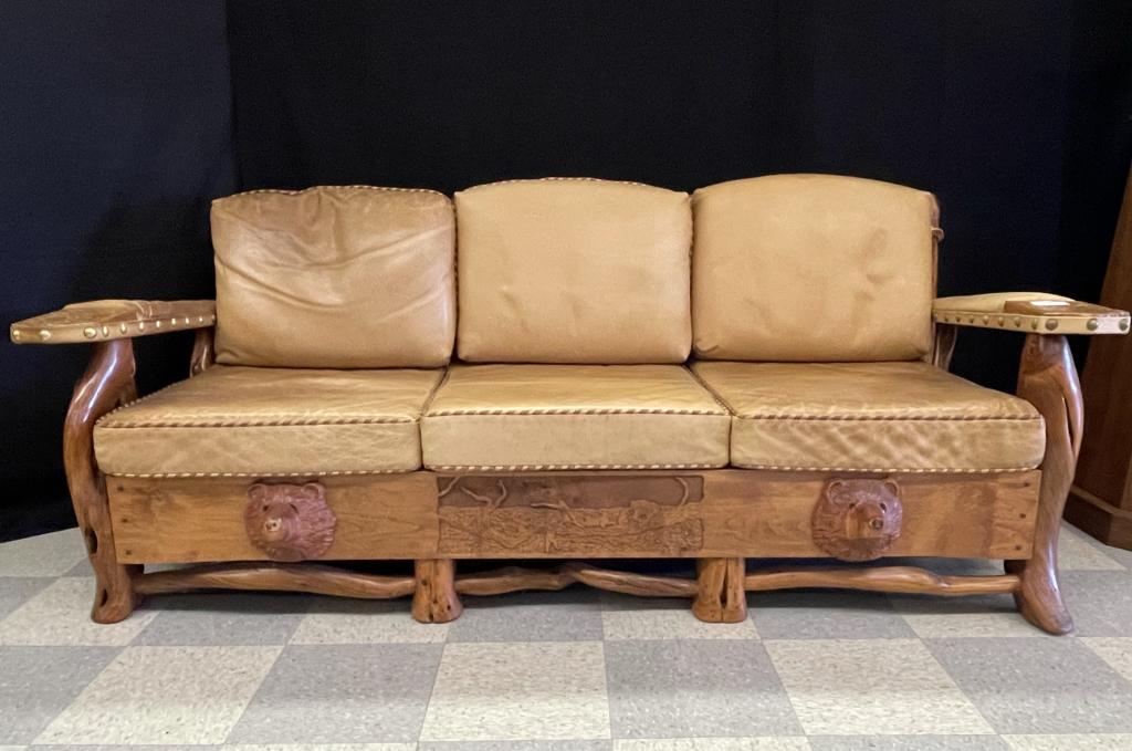 Lester Santos Western Leather Sofa: made in the Thomas Molesworth style in Cody, WY with carved bears, made with juniper legs and copper drink rests. Structurally sound and in very good condition. Leather cushions have some staining and