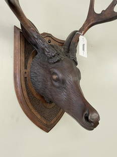 Black Forest Carved Deer Head: with carved wooden antlers and shield plaque. 18" spread on horns. Some antlers have been repaired.