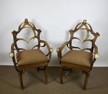 Pair of Elk Antler Arm Chairs: with upholstered seats, both very solid and in very good condition, 42" tall.