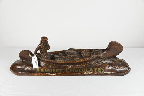 Samoset Chocolates Store Advertising Piece: Native American paddling birch bark canoe, made of synthetic material, some paint flaking, 3' long.