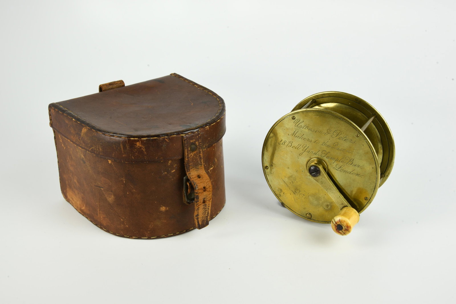 Very Rare Ustonson & Peters Brass Salmon Reel: 4” diam, 1 3/4” spool width, circa 1848-1855, marked in jeweler’s script "Ustonson & Peters Makers to the Queen 48 Bell Yard Temple Bar". Featuring a crank handle fitted with a bone 