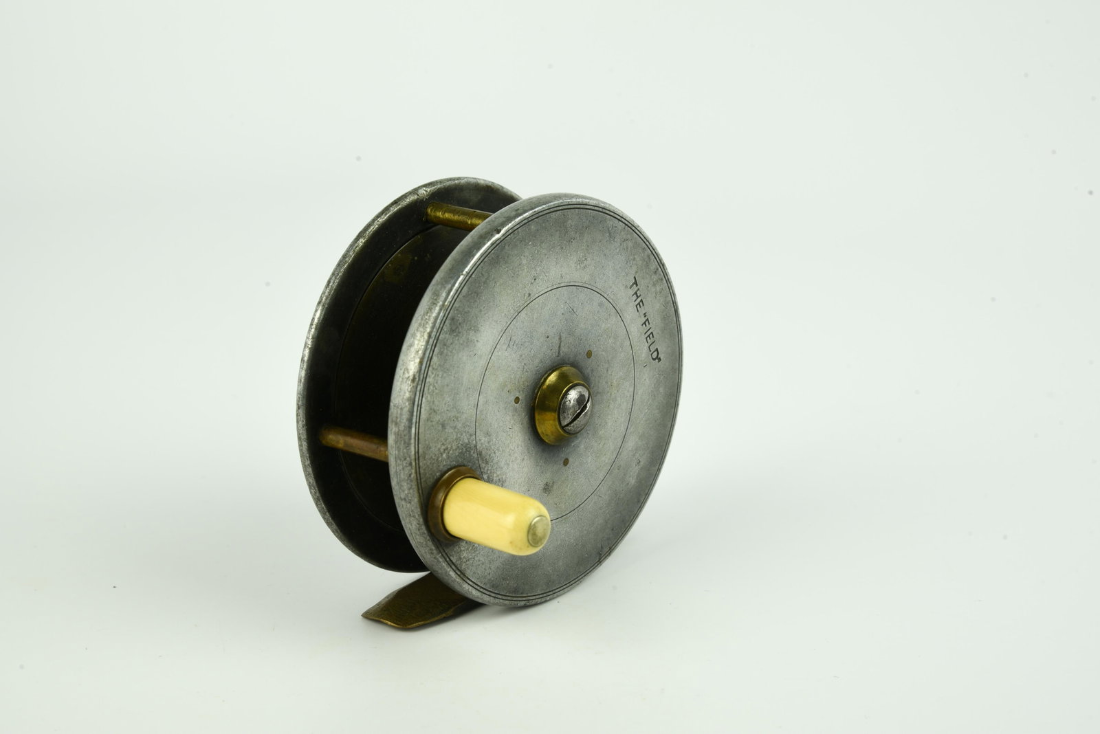 Hardy The “Field” Fly Reel: Rare, 3 1/4” diam, 13/16” wide spool, marked with the closed oval logo and “Hardy’s Pat.” with The “Field” on the face, brass pillars, smooth brass foot, VG/V