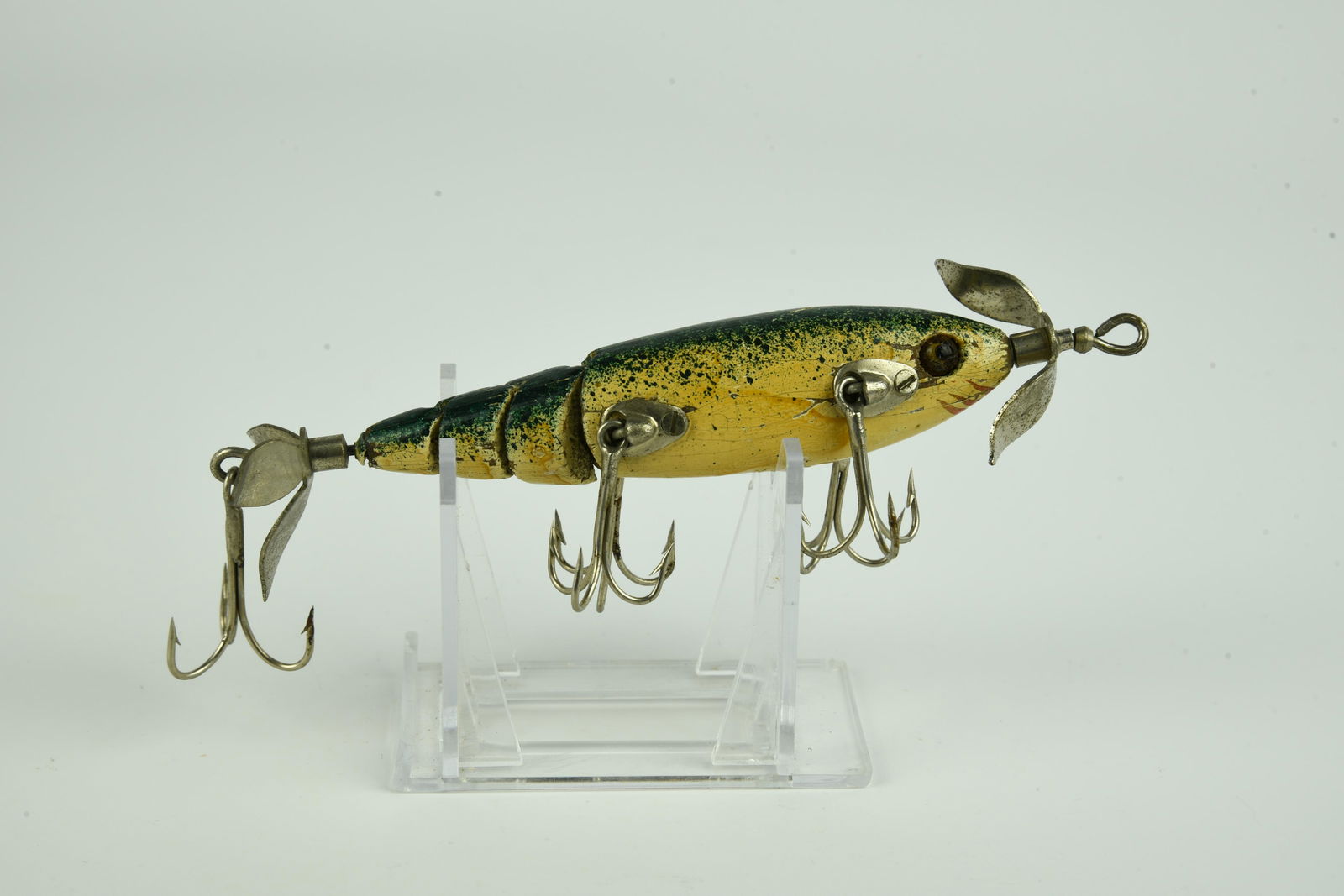 Michigan Life-Like Minnow: Unique jointed body measuring just over 3 1/2”, in mottled green back over white with hand painted gill marks, rear three bladed prop marked PAT Feb 25th 1908, and rigged with the harder to find