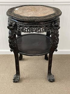 Heavily Carved Marble Top Stand: with inset red marble top and ball and claw feet. Pierced carved border and a lower shelf. 32" tall. 24" diameter top.