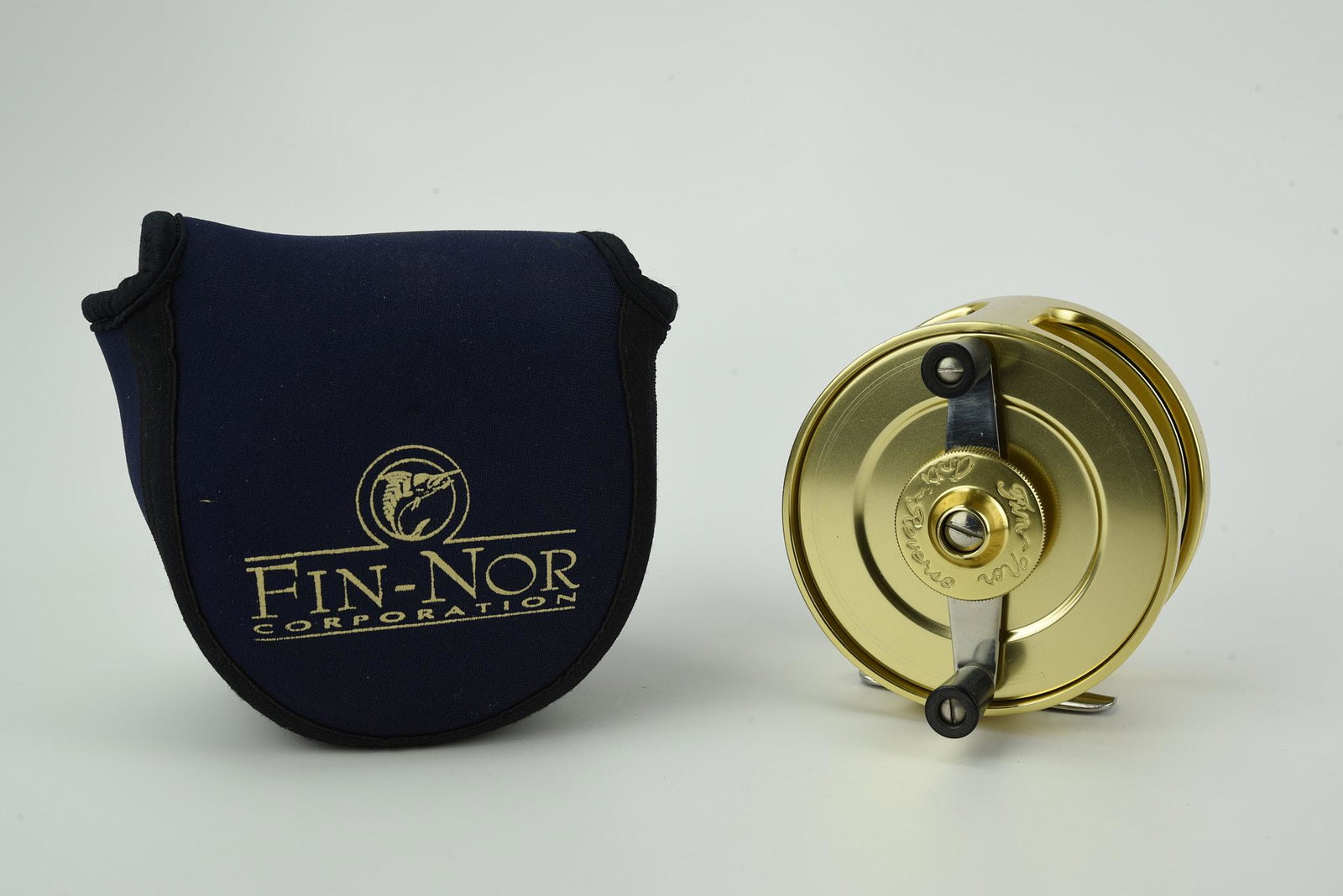 Fin-Nor No.4 Anti-Reverse Reel: 3 5/8" diam, 1 1/2" wide spool, set for left hand wind, "Since 1933" marked convex tail plate VG+/Ex-, in a Fin-Nor marked reel pouch.