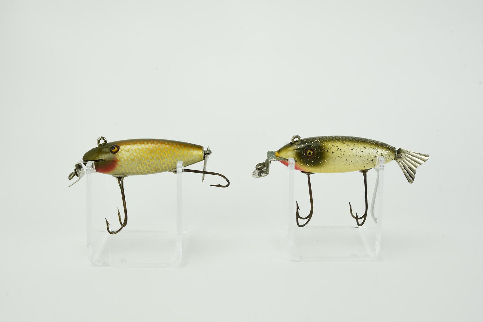 2 Creek Chub Deluxe Wagtails: Each with a fluted tail, double line tie and dated lip, including a tough golden shiner with a silver belly, circa 1921/22, with the exception of a cut hook barb about Ex-. And silver flash, also abou