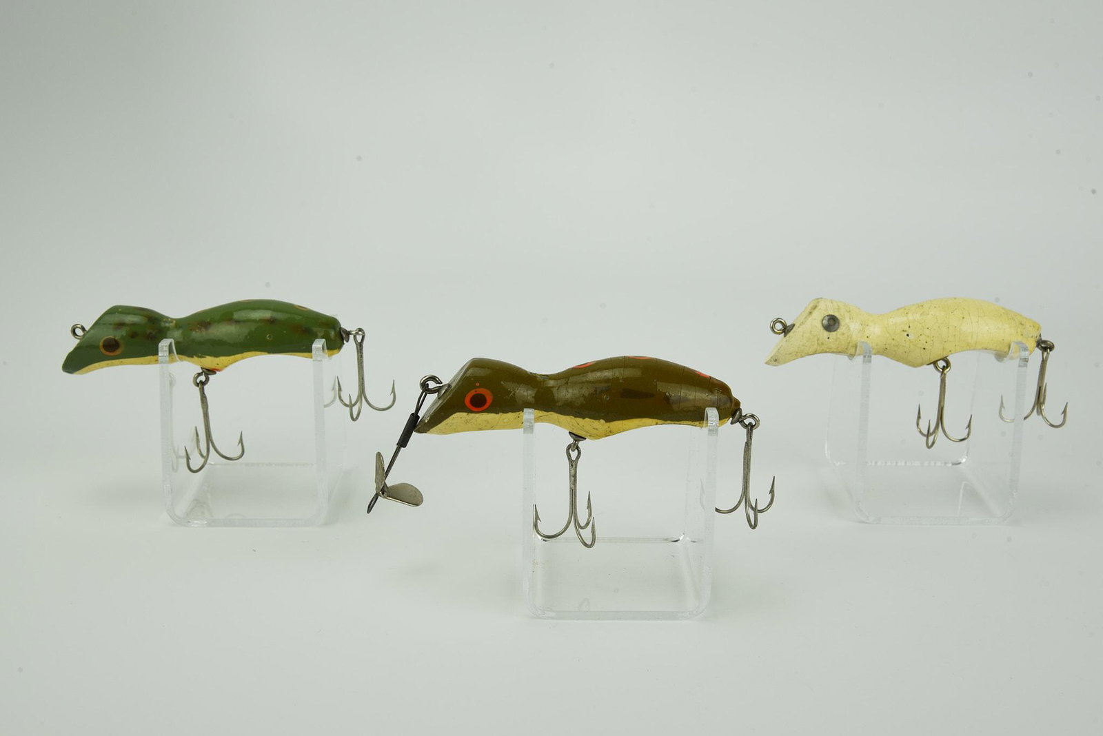 3 Brown's Fisherettos: Includes an early scarce solid white with washer eyes, and two in frog finish, one spinner rigged. Condition from VG/VG+ to shiny Ex-.