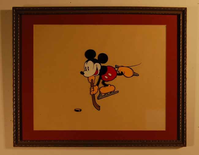 Disney Cel: Mickey Mouse playing hockey. Sight size 8" x 10". Overall size 10 1/2" x 13 1/4". (From an upstate NY Doctor's Estate that has been untouched for over a decade)