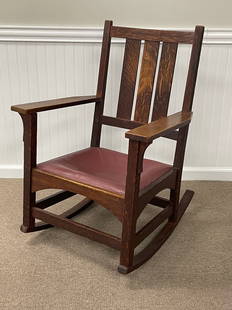 Gustav Stickley Arm Rocker: Signed with red decal. Dark brown finish, arched stretcher, Some wear, good condition. Replaced leather.