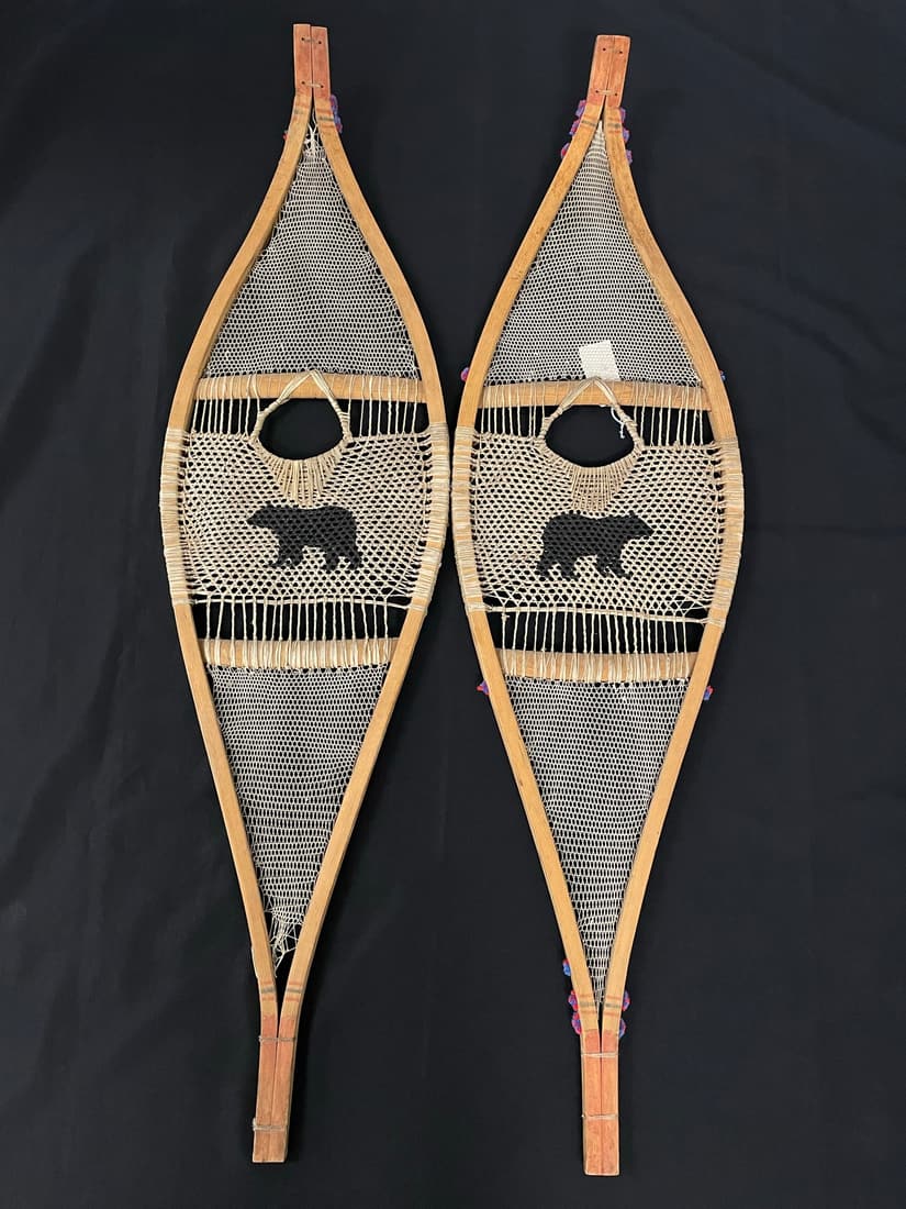 Native American Hand Woven Snowshoes: with colored tassels and black bear silhouettes 51" long.