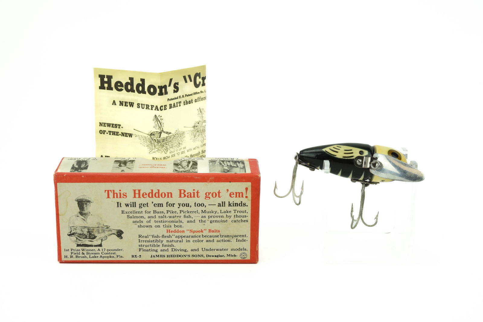 Heddon Cone Tail Crazy Crawler: 2120BWH black body/white head with wings, 2pc hardware, bright and shiny, most likely unfished, at least Ex-/Ex. Correct end stamped Brush box is Ex- with a nice Heddon’s "Crazy-Crawler" paper.