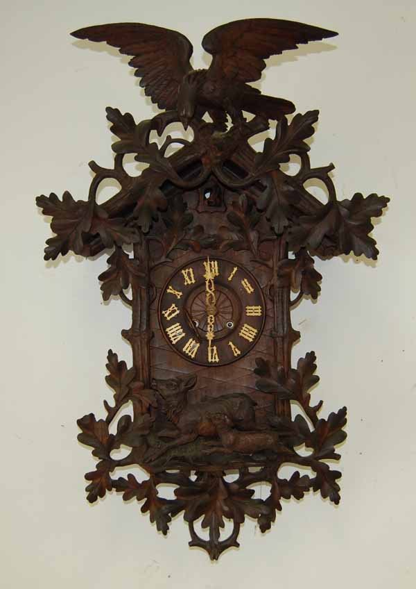 Black Forest Cuckoo Clock: with key and pendulum. 36" tall. This clock has hung in the same camp in Saranac Lake for several generations. It was used as decoration and the family has not wound it in years.