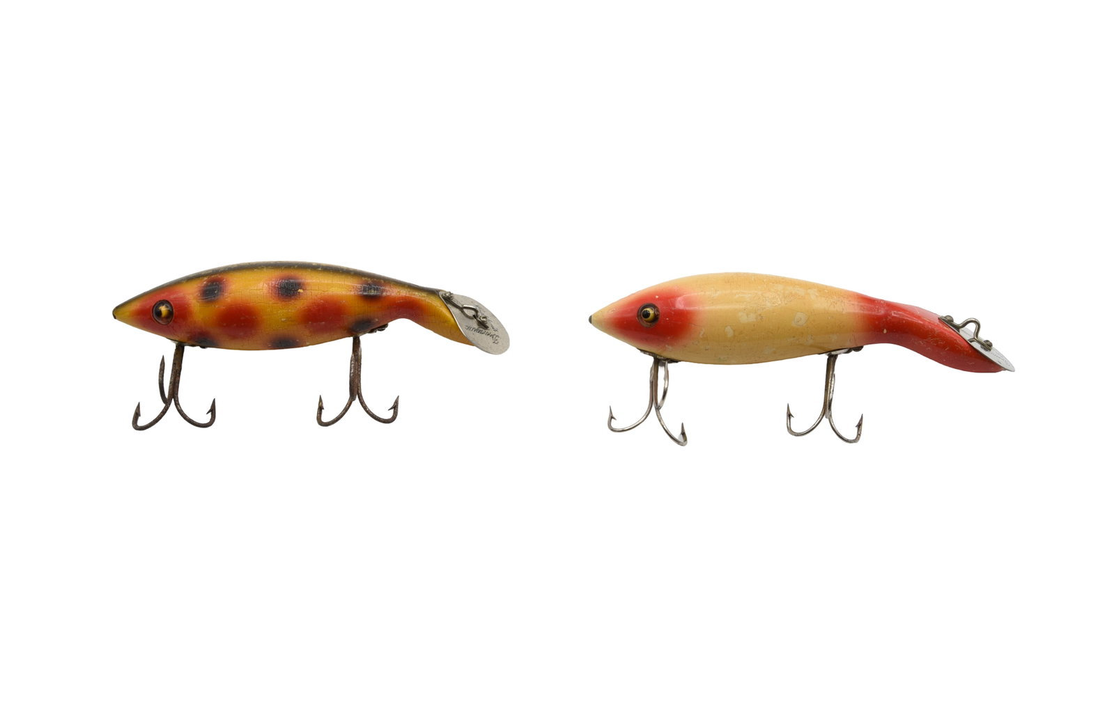 2 Heddon Tadpollys: Each with L-rig hardware and a bell diving plate. 6000 in white with red eye and tail, good glass eyes (VG/VG+), and a yellow strawberry spot 5000, L-rig (about VG-).