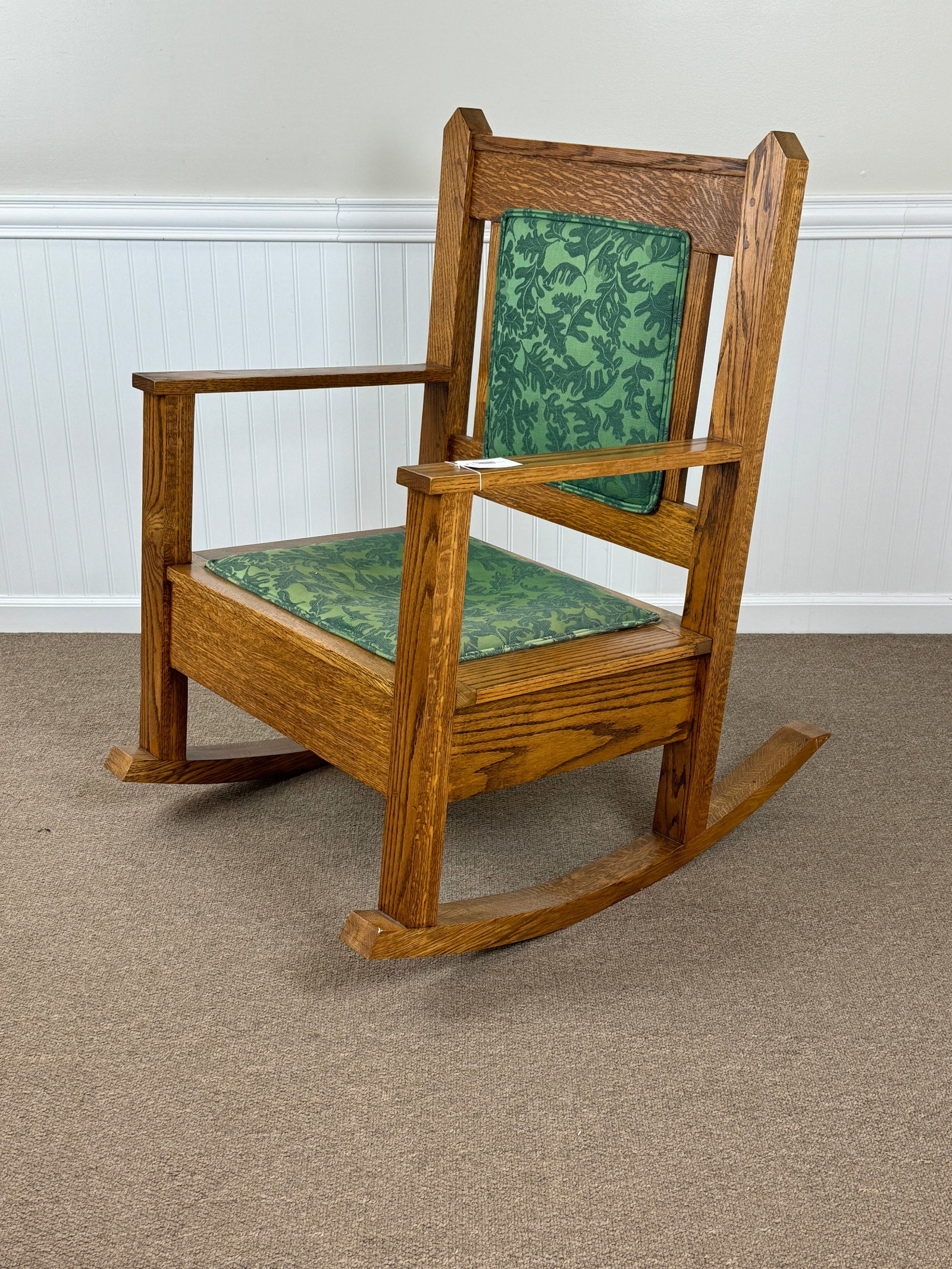 Mission Oak Oversized Arm Rocker: light brown finish, oak leaf upholstery. 27" wide x 41" tall.