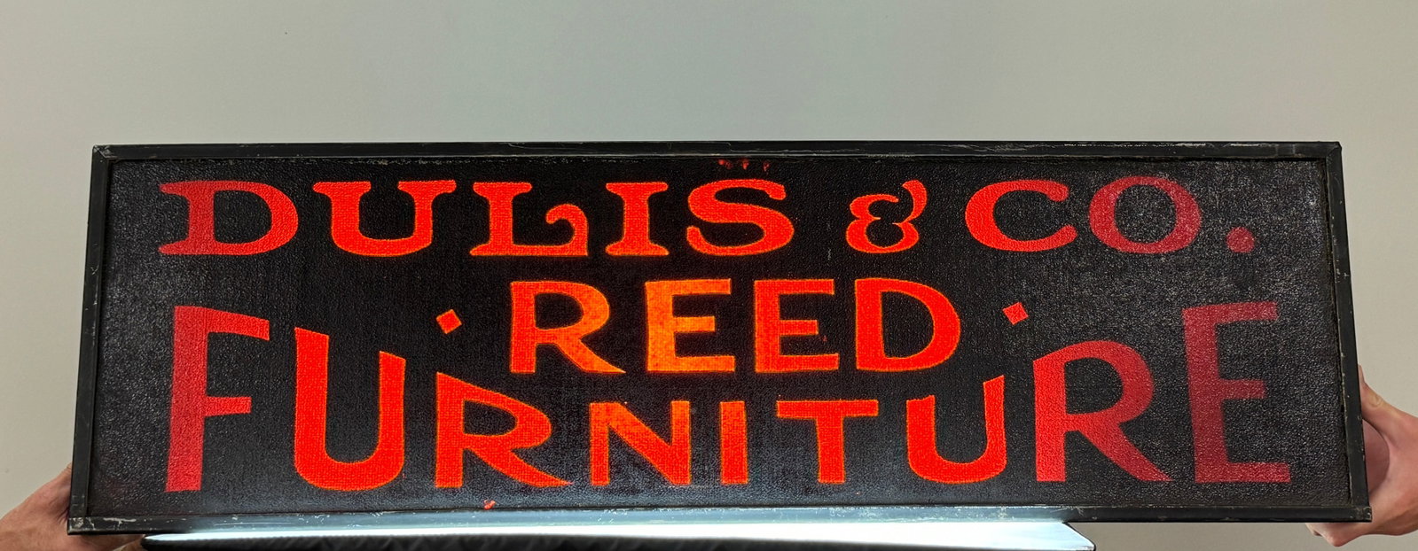 Dulis & Co Reed Furniture Advertising Sign: Reverse painted on glass with metal case. Made to be lit up. 40" long x 12" high.